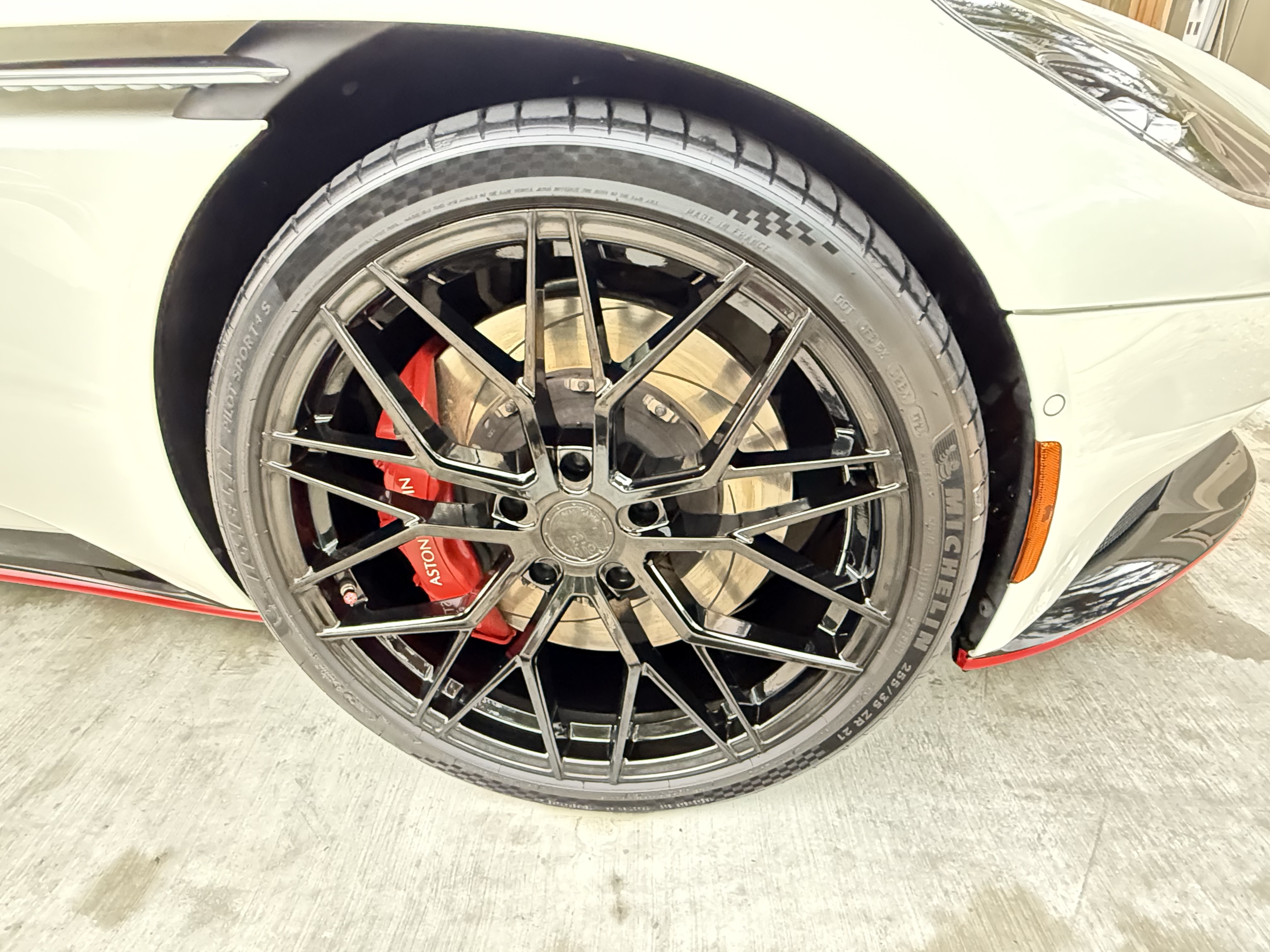 Aston Martin wheel detail with red calipers showcasing quality finish